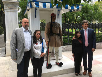 Andreas Dracopoulos, President of the Stavros Niarchos Foundation, together with members of the Special Olympics, being photographed in front of a cholias